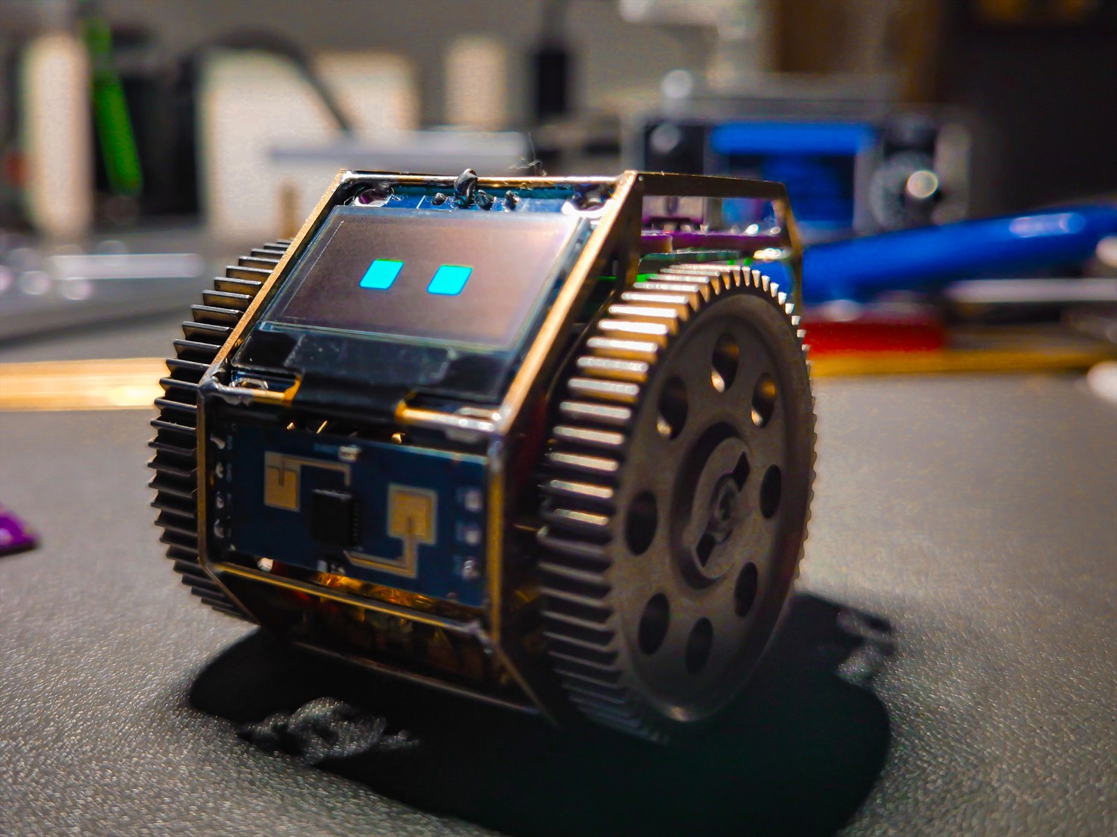 Real TongDou prototype on a workbench with OLED eyes awake
