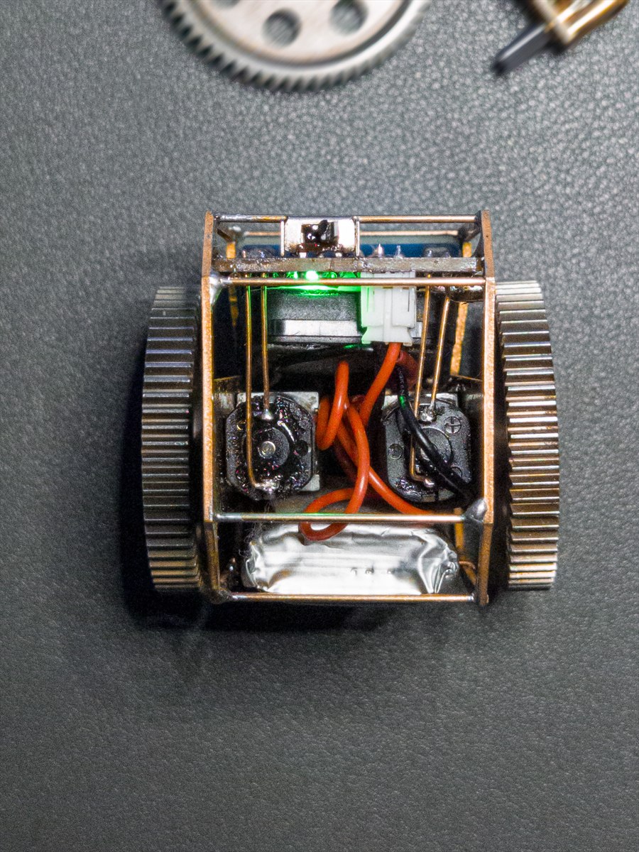 Real TongDou prototype opened to show motors, battery, wiring, and brass frame
